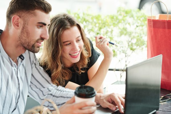 Cheerful couple shopping online